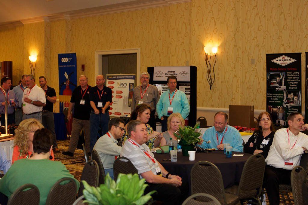 A group of people are sitting at tables in a room.