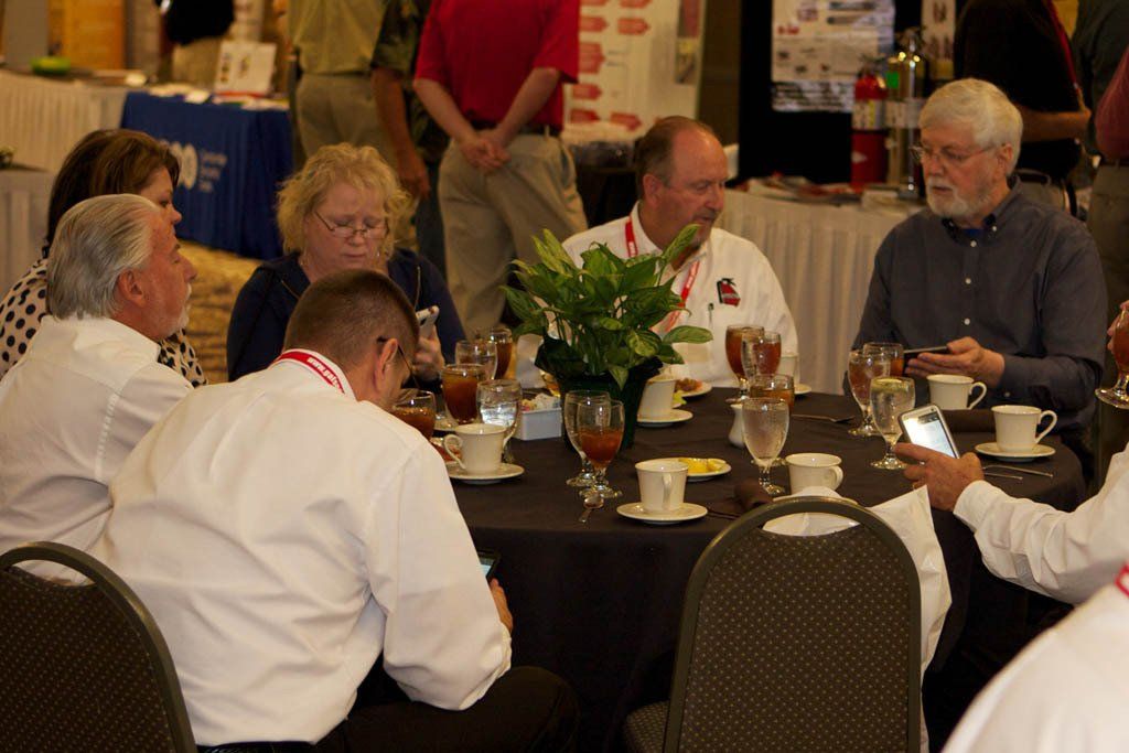A group of people are sitting around a table talking