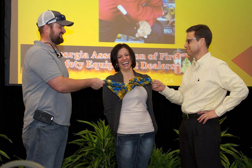 Three people are standing in front of a screen that says georgia ace