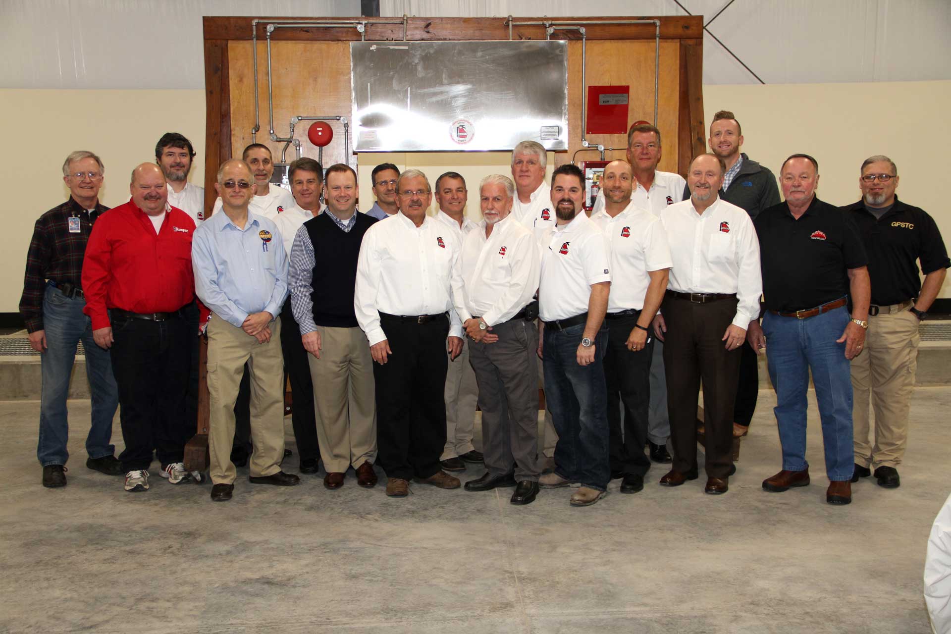 A group of men are posing for a picture in a room