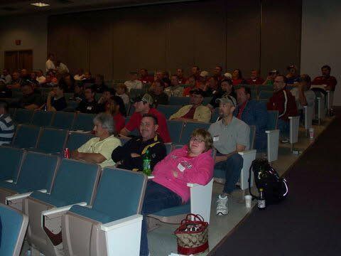 A group of people are sitting in a theater watching a movie.