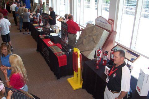 A man stands in front of a table with a fire extinguisher on it