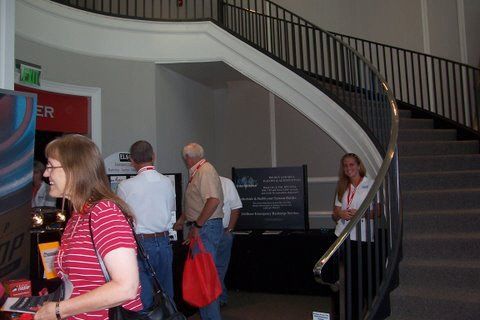A woman stands in front of a sign that says exit