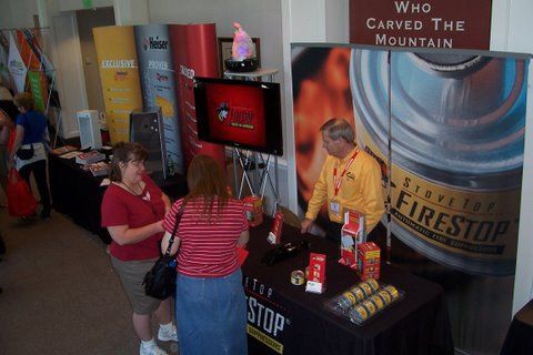 A group of people standing around a table with a sign that says who carved the mountain