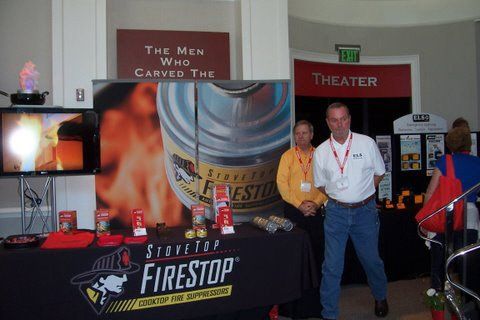 Two men standing in front of a firestop table