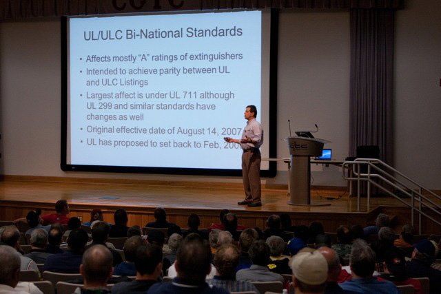 A man is giving a presentation on u.u.l.c. b-national standards