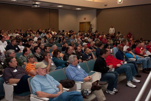 A large group of people are sitting in a lecture hall