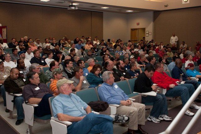 A large group of people are sitting in a lecture hall