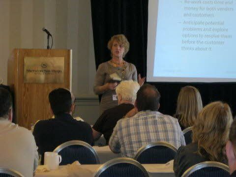 A woman is giving a presentation to a group of people