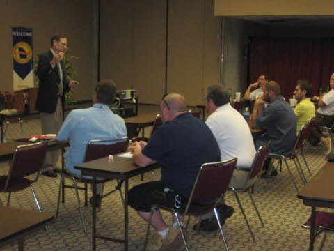 A man is giving a presentation to a group of men