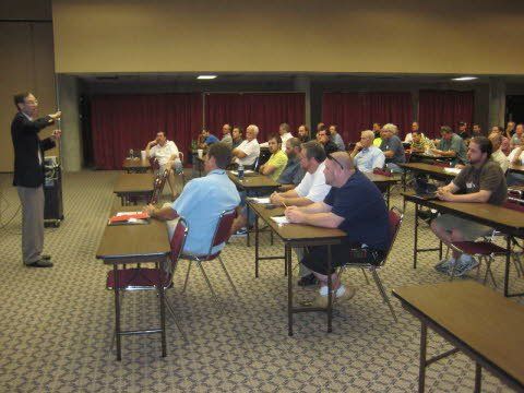 A man is giving a presentation to a group of people