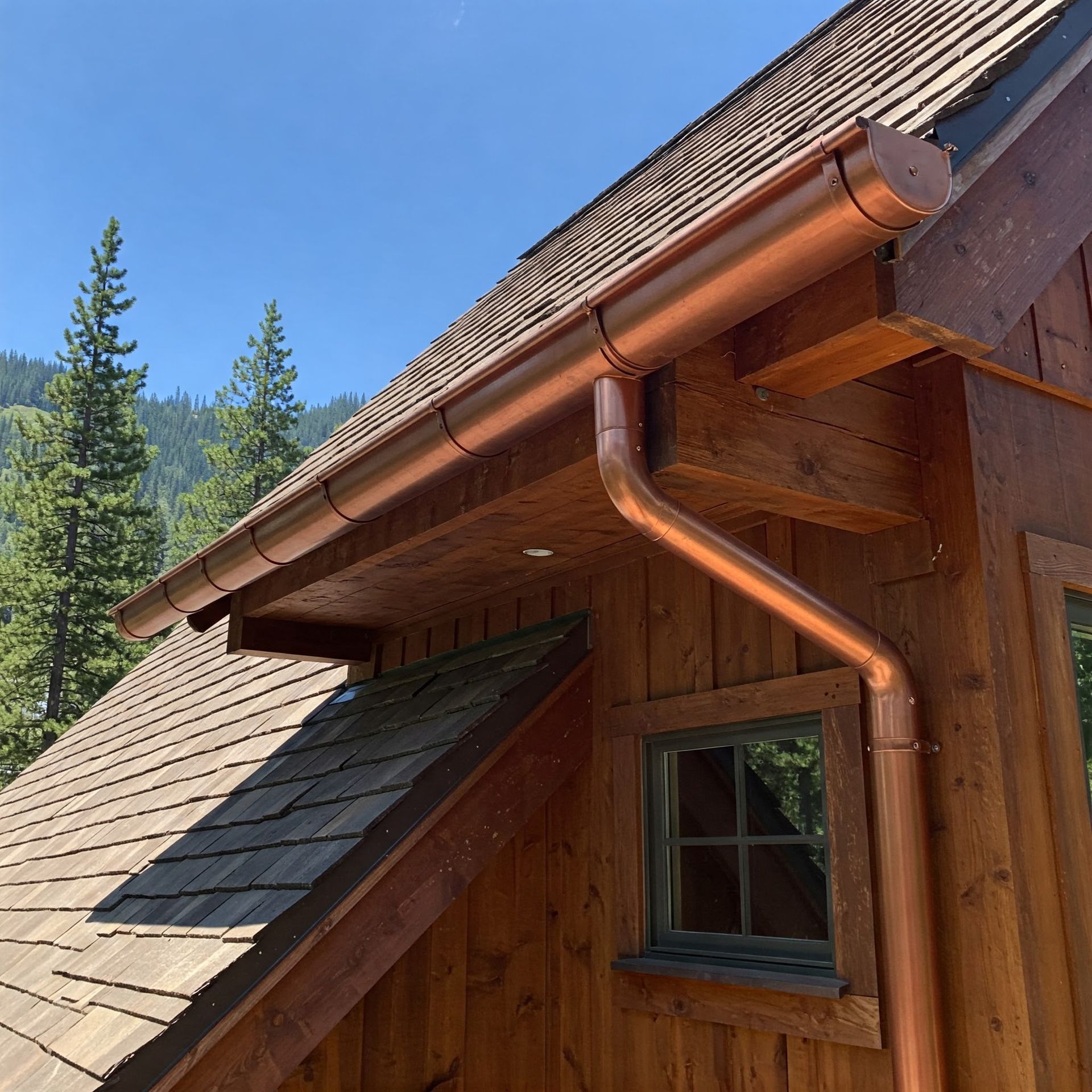 A house with a copper gutter on the side of it.