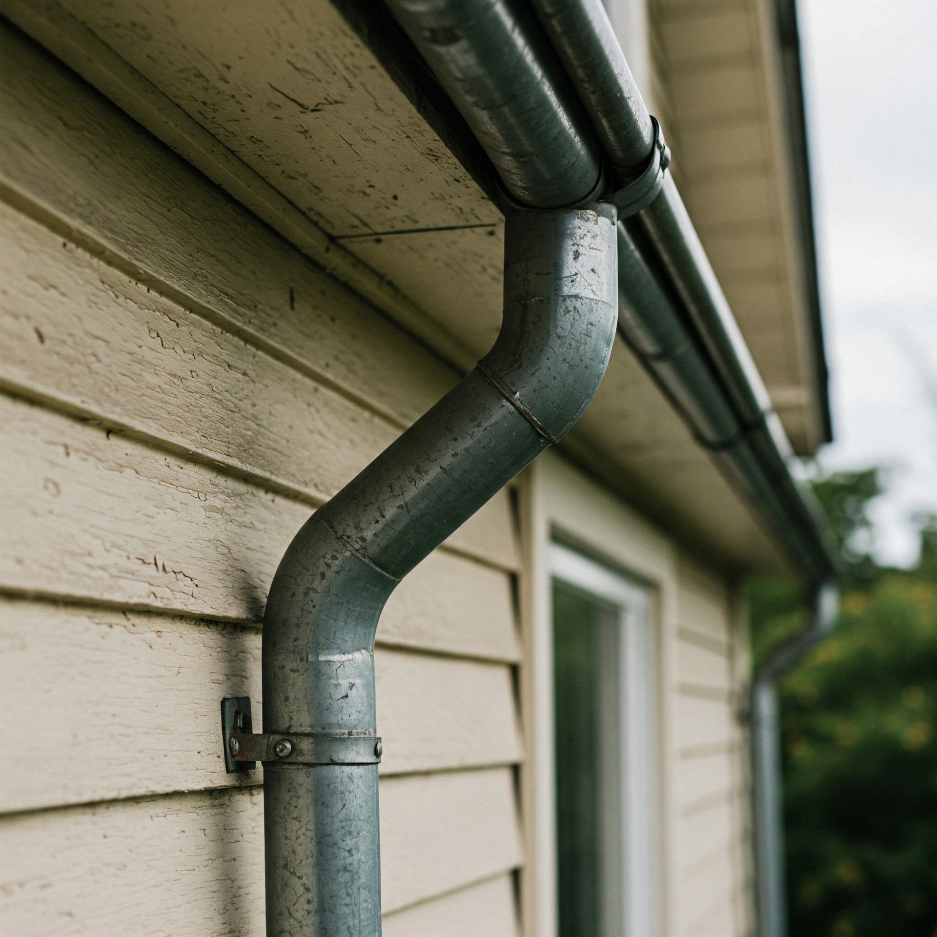 A close up of a gutter on the side of a building.