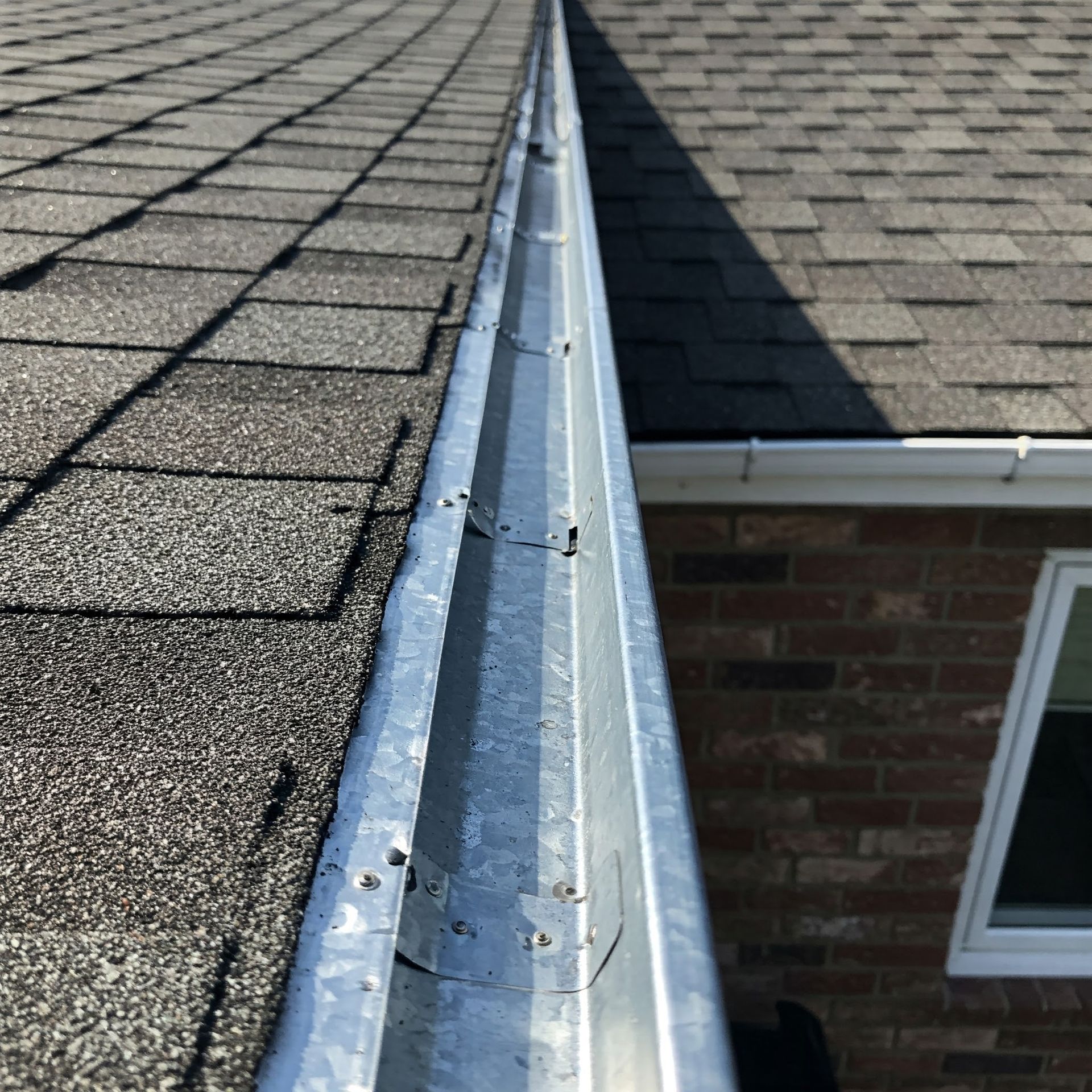 A close up of steel gutter on the roof of a house.