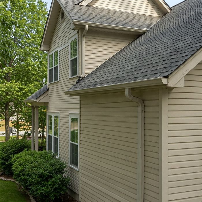 A house with a gray roof and white siding