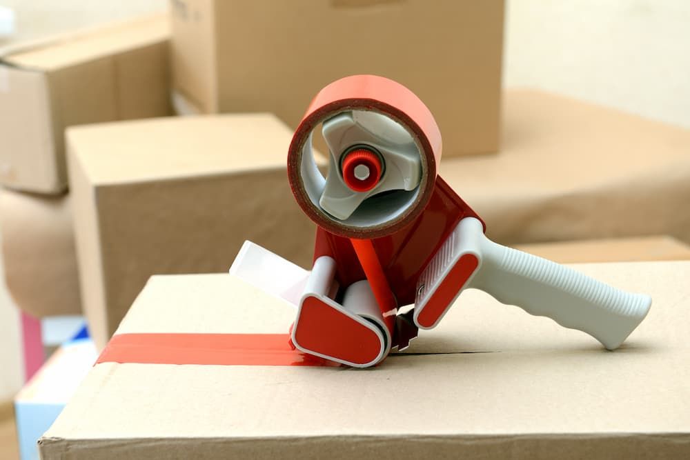 Tape gun on card board bo