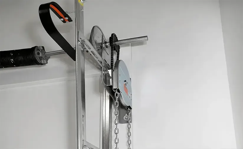 A machine is hanging on a wall with a chain attached to it.