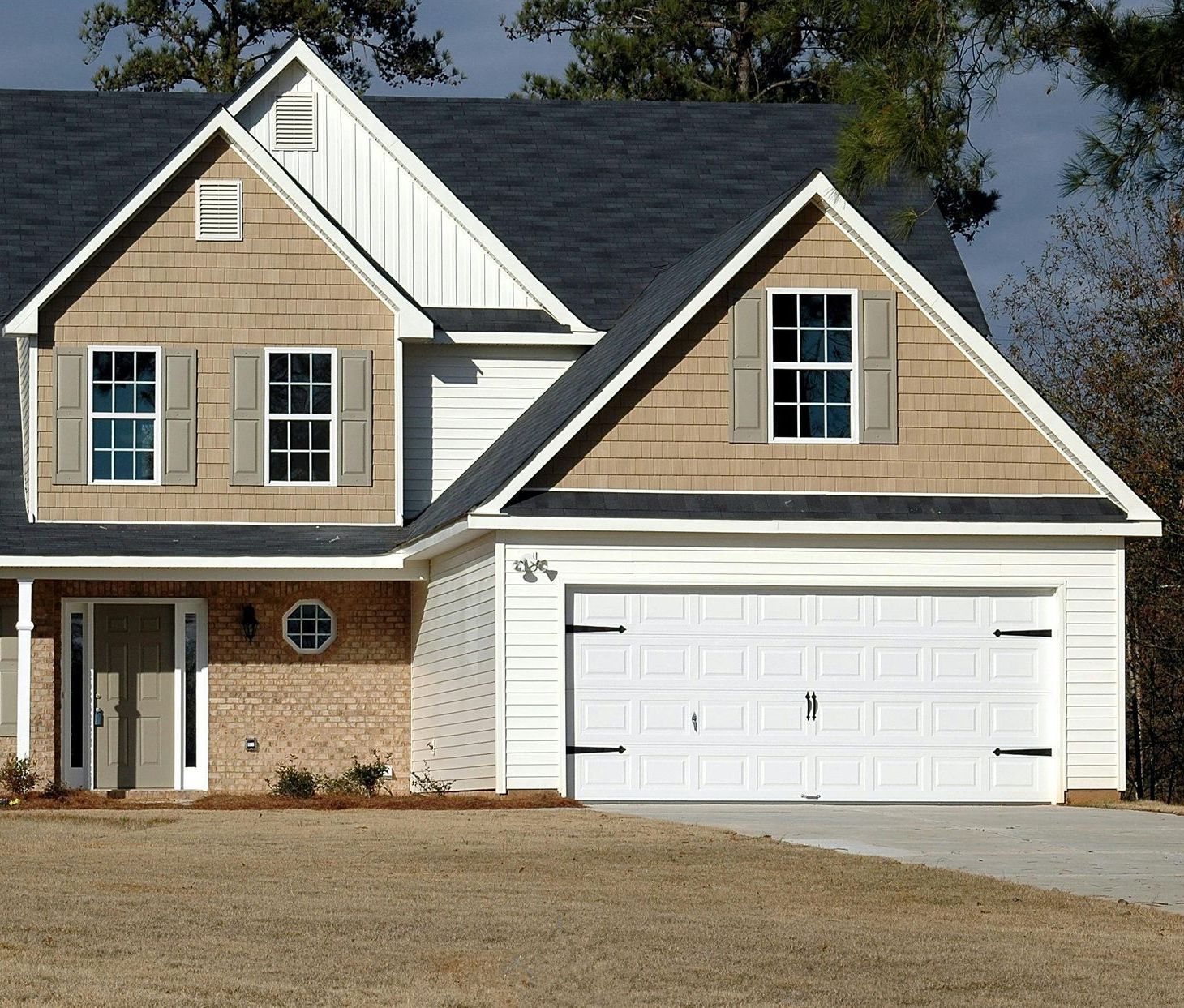 The front of a house with a white garage door
