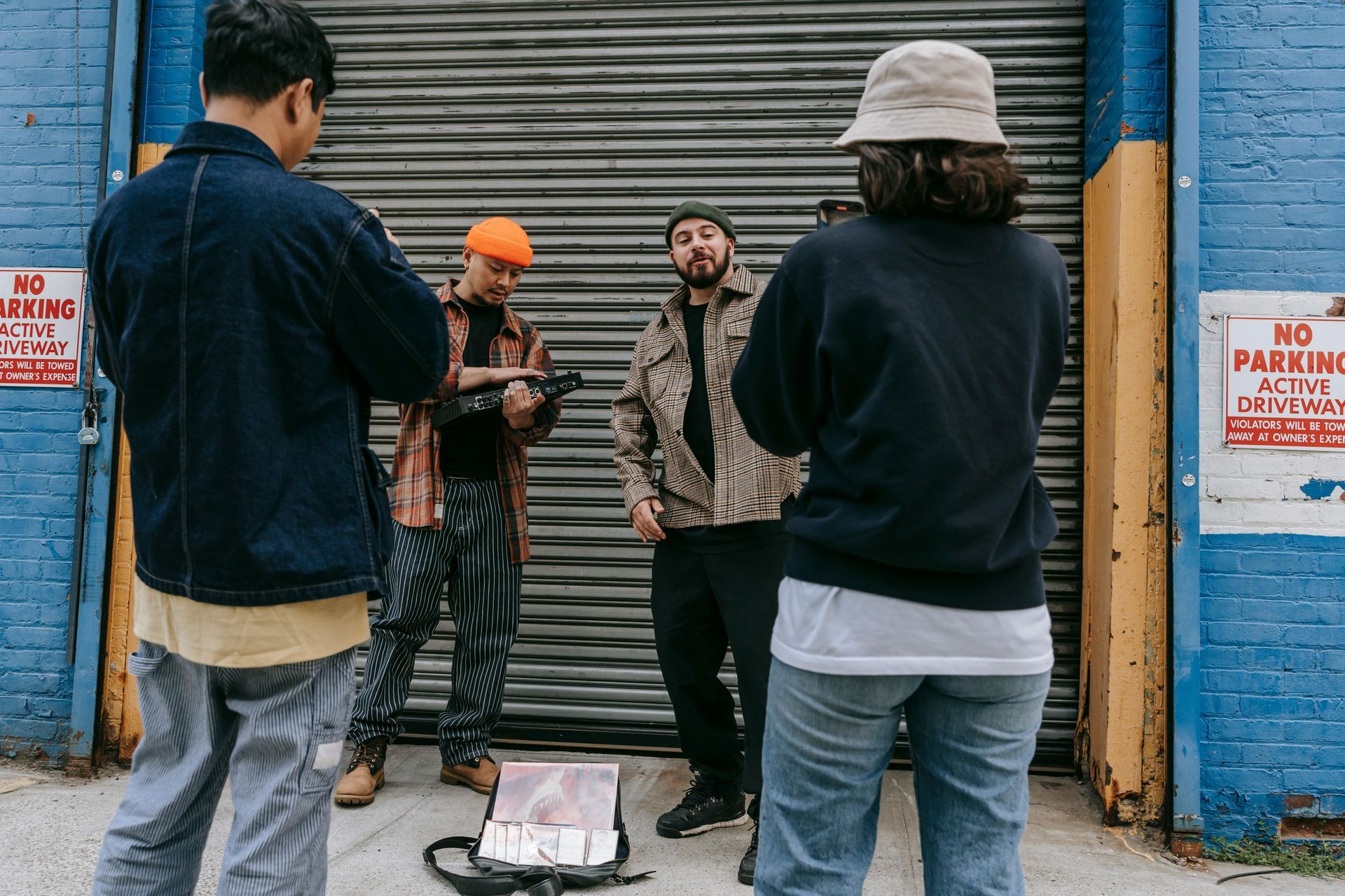 A group of people are standing in front of a no parking sign.