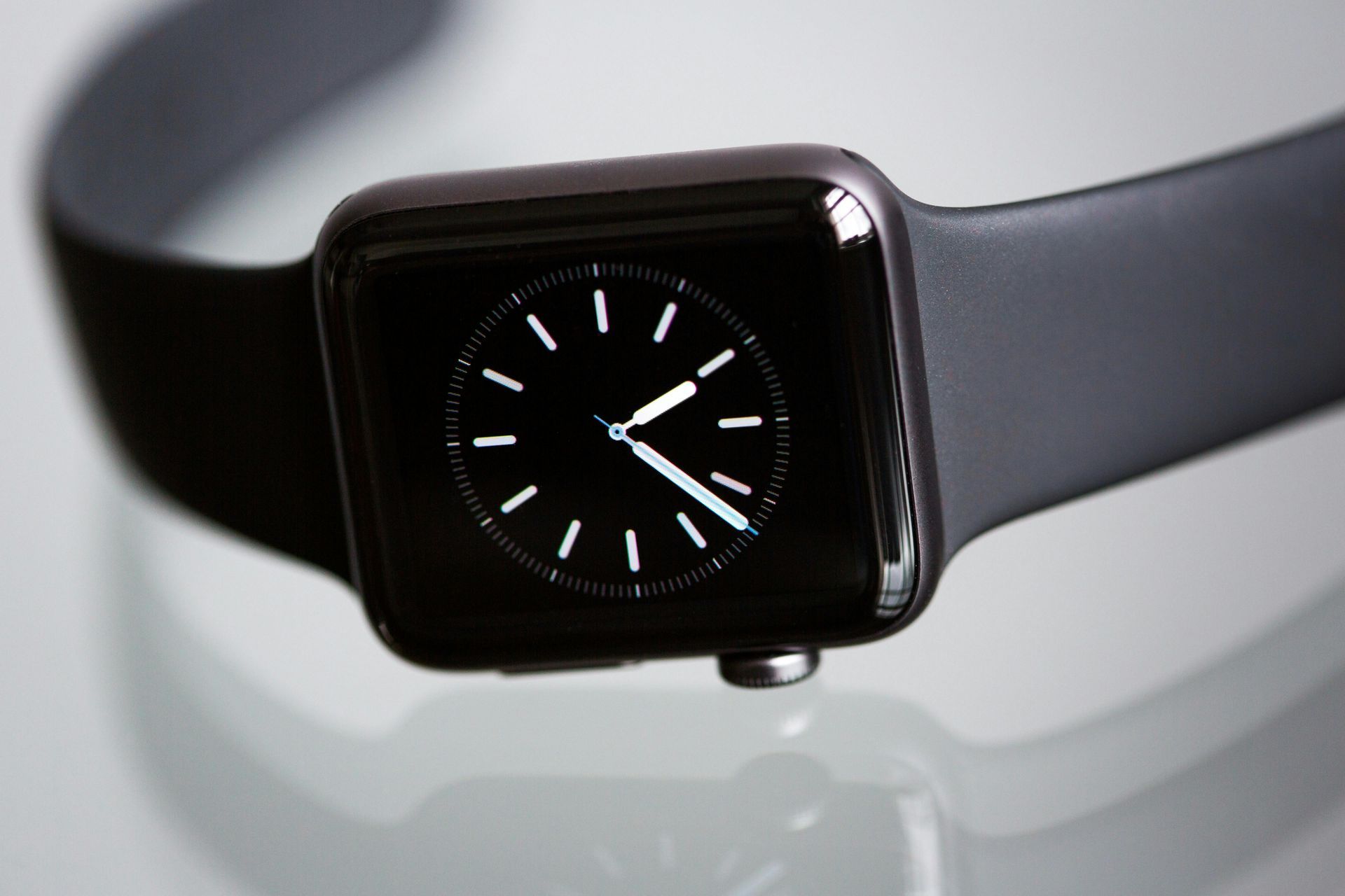 A close up of an apple watch with a black band