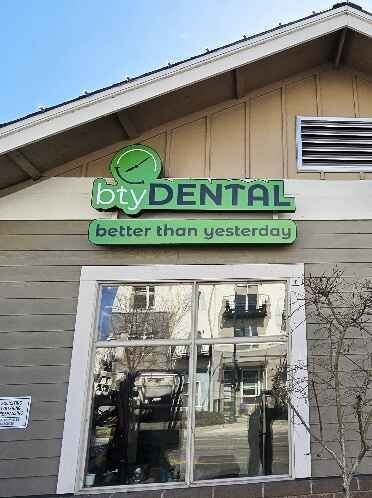 A green sign for Bty Dental with the slogan 