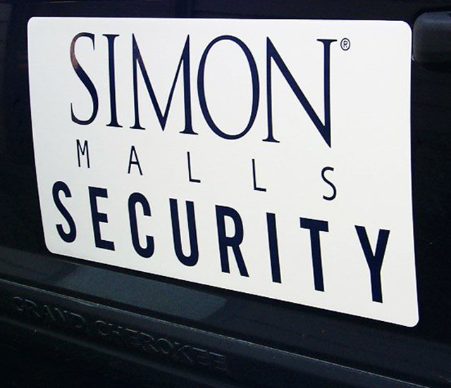 A white sign on a black vehicle with black text reading 