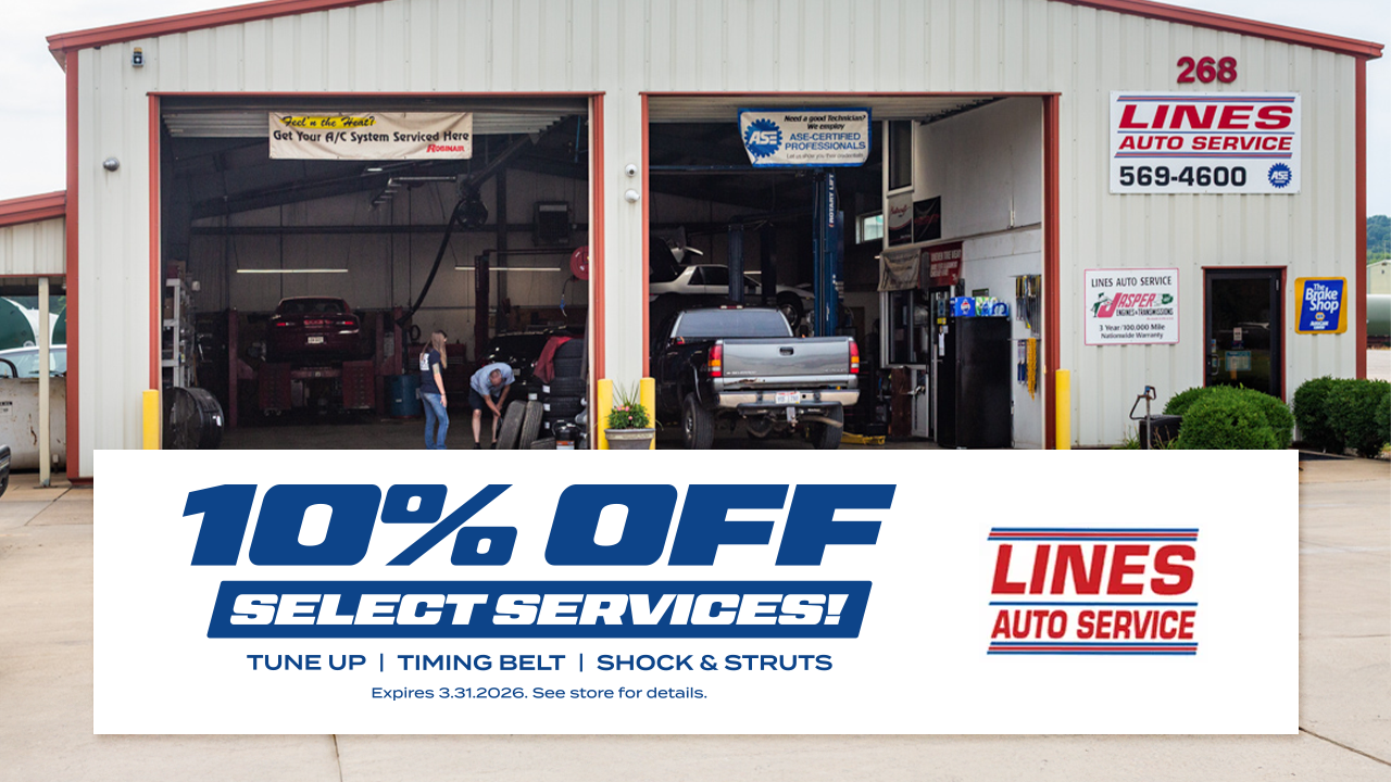 Auto repair shop with open garage bays, offering 10% off select services.