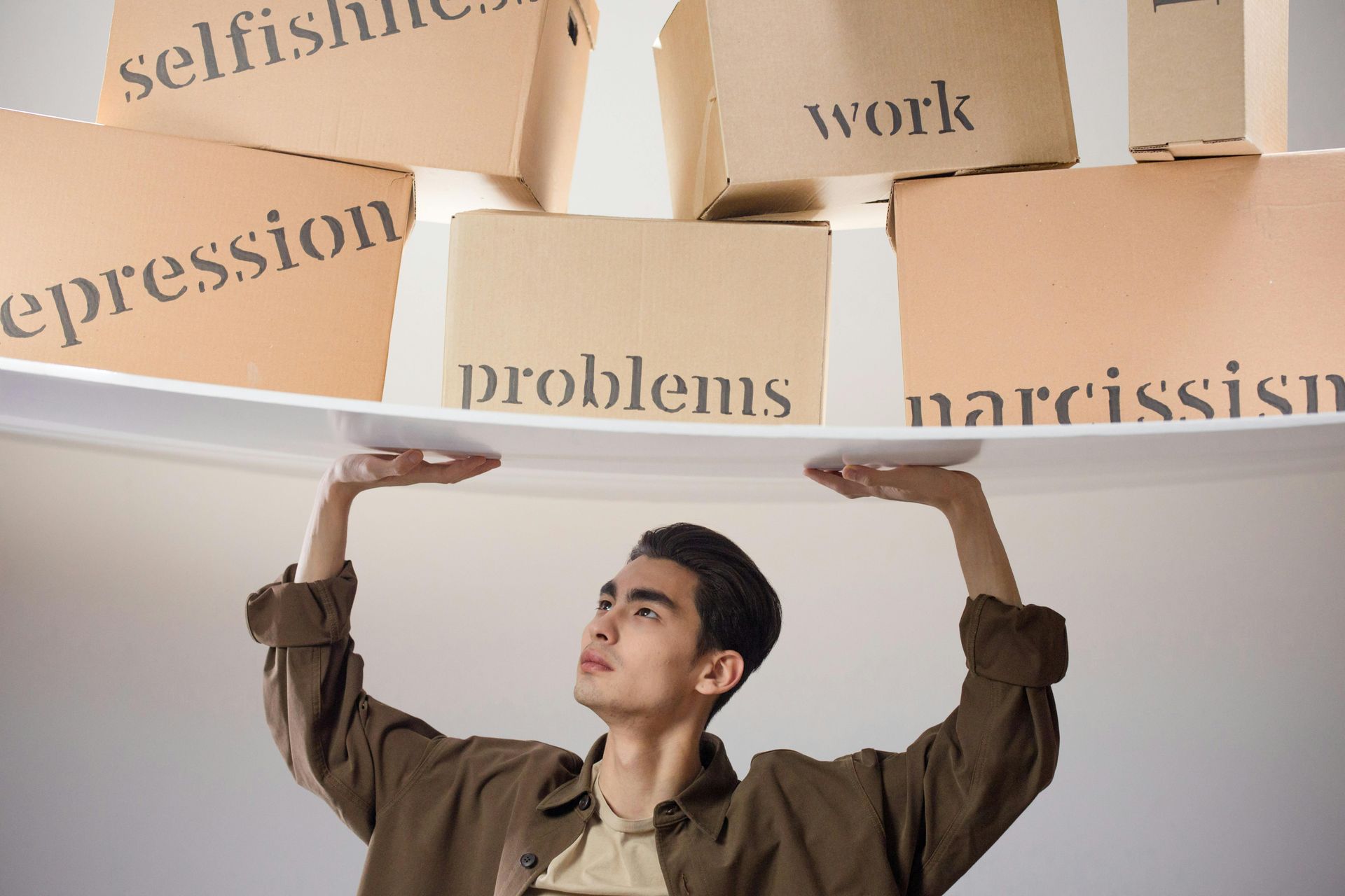 A man is holding a piece of paper over his head.