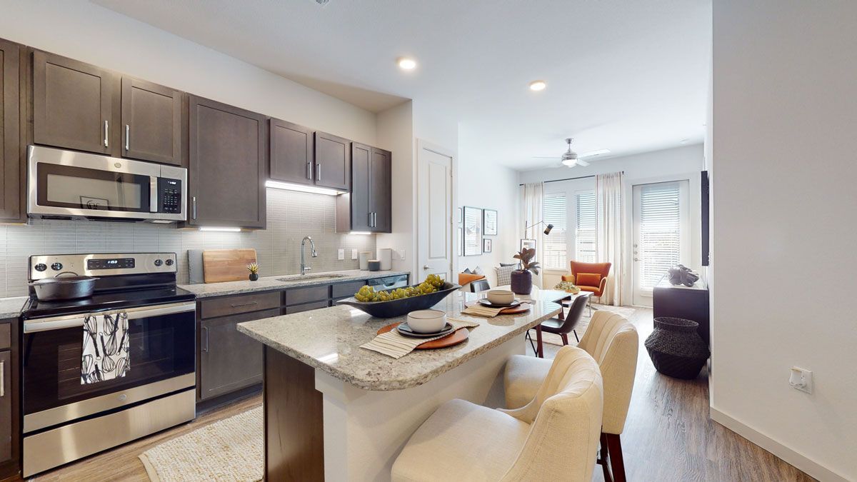 A 3d model of a kitchen with stainless steel appliances and granite counter tops.