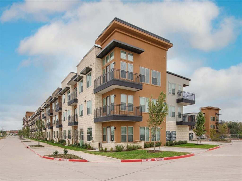 A large apartment building with a lot of windows and balconies