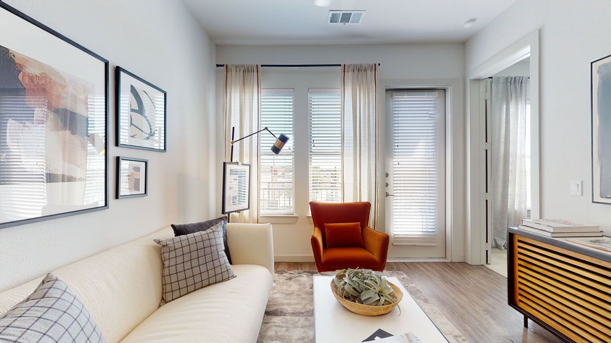 bright living room with patio door and window