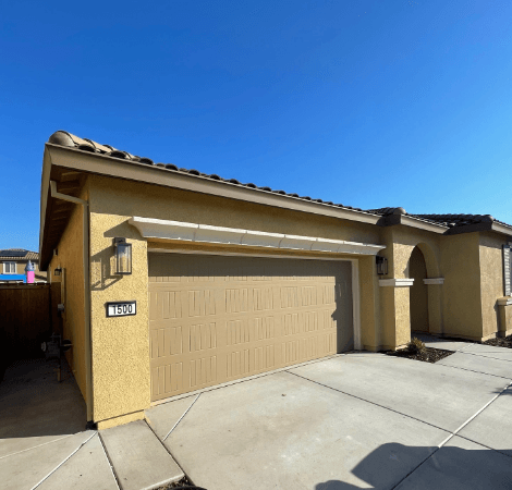 A house with a garage and a sign that says thru