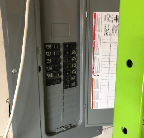 A gray and green electrical box with a label that says ' a ' on it