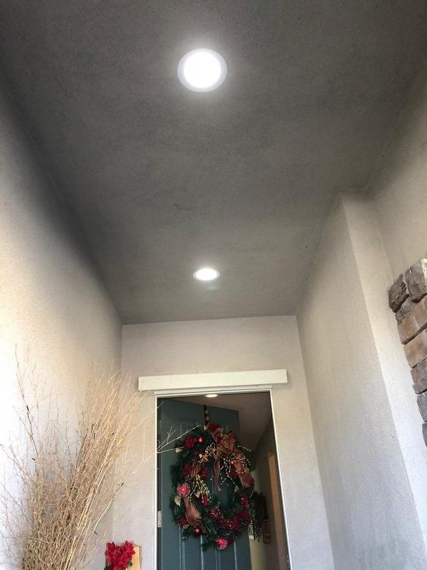 A hallway with a christmas wreath hanging on the door.