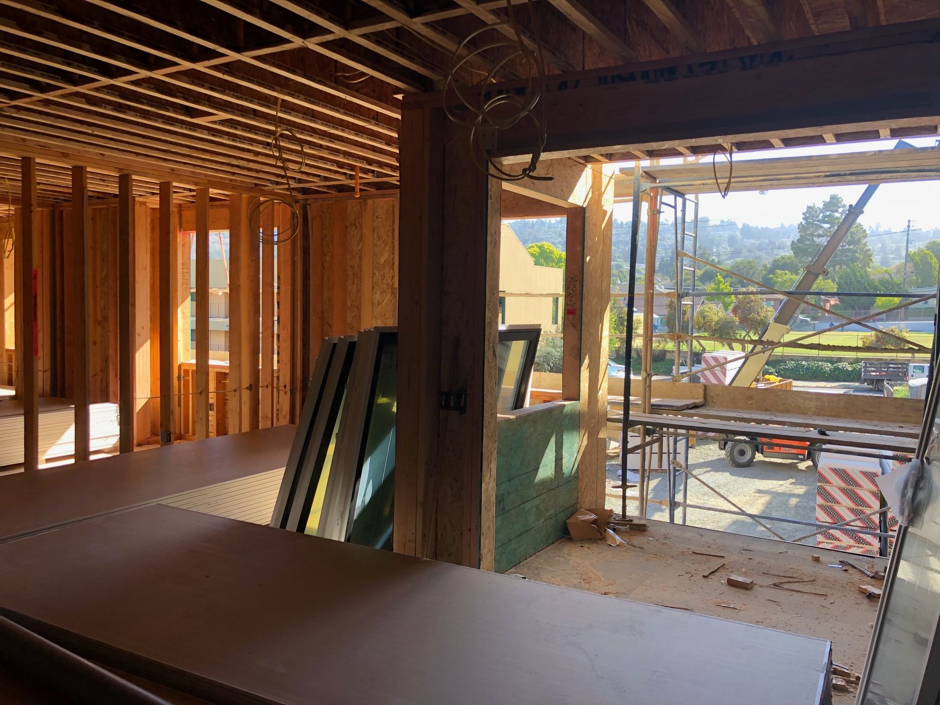 A house is being built with a lot of wood and a lot of windows.