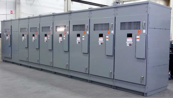 a row of electrical cabinets are lined up in a room