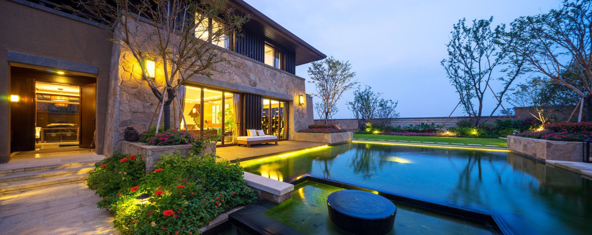 A large house with a swimming pool in front of it.