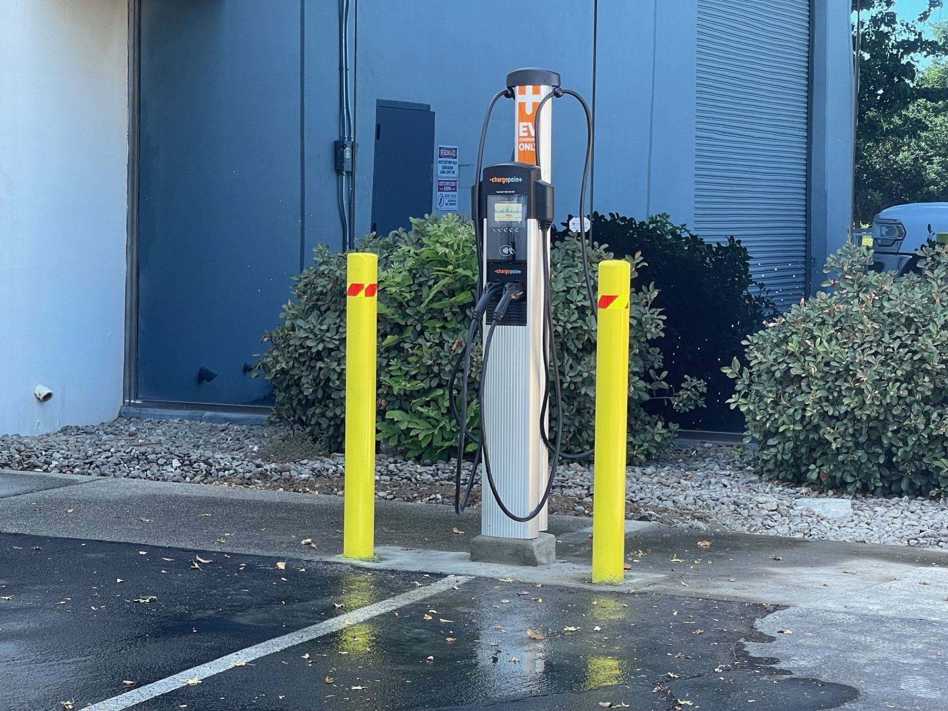 An electric vehicle charging station in a parking lot