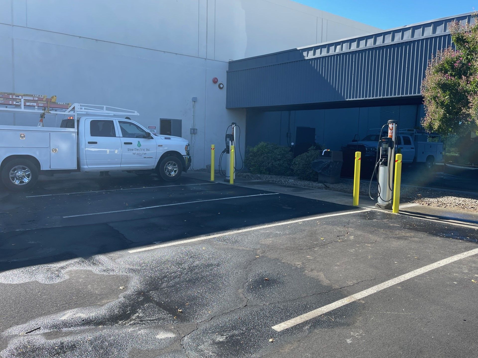 A white truck is parked in front of a building