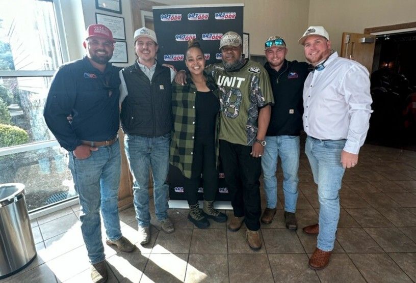 Chapman’s Construction team members with the radio hosts during the Hometown Heroes event.