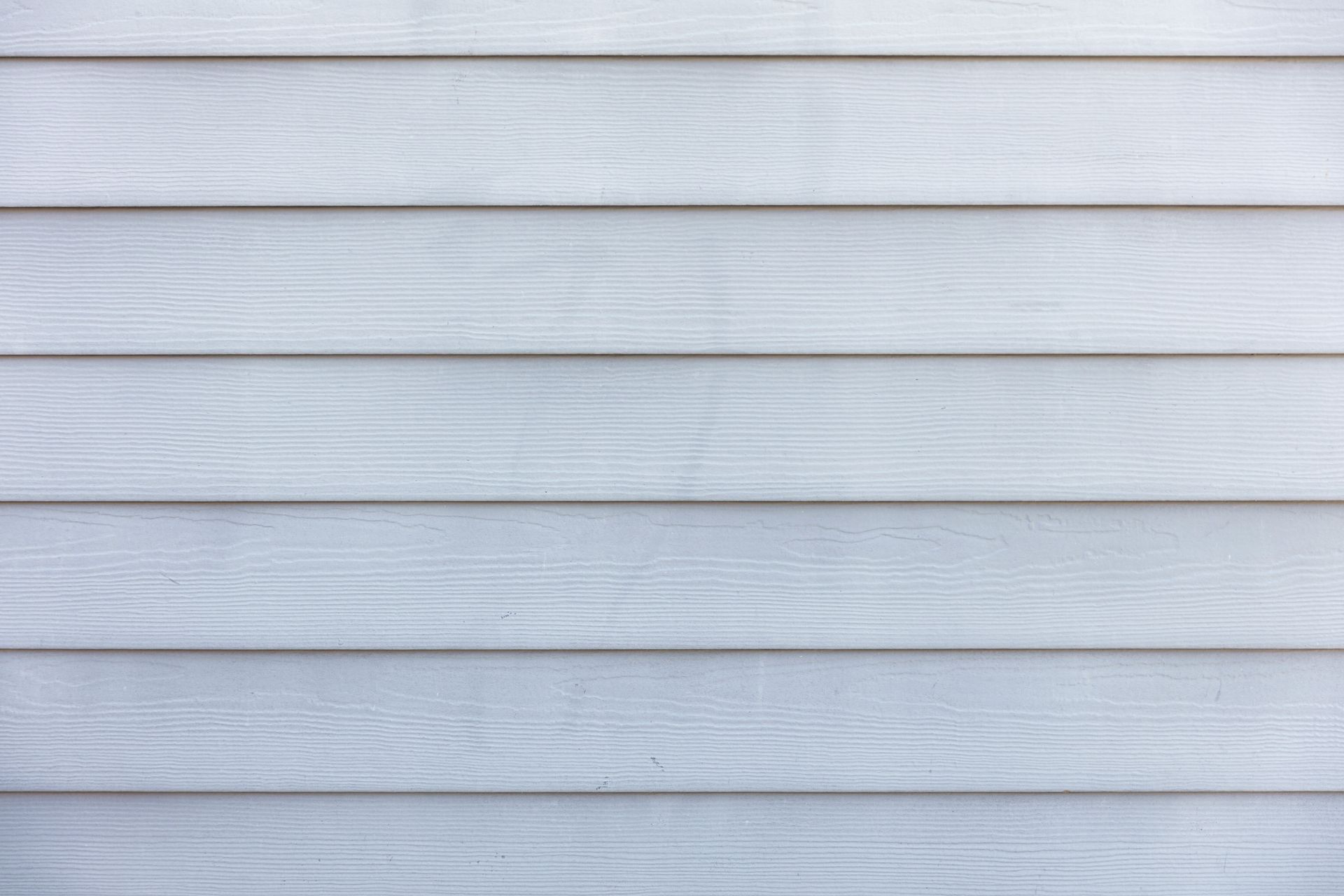 Horizontal light gray wooden planks with subtle grain and white trim lines.