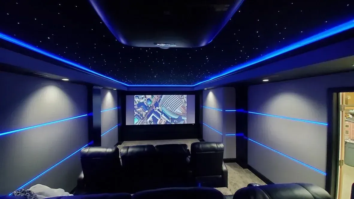 A room with a flat screen tv and speakers