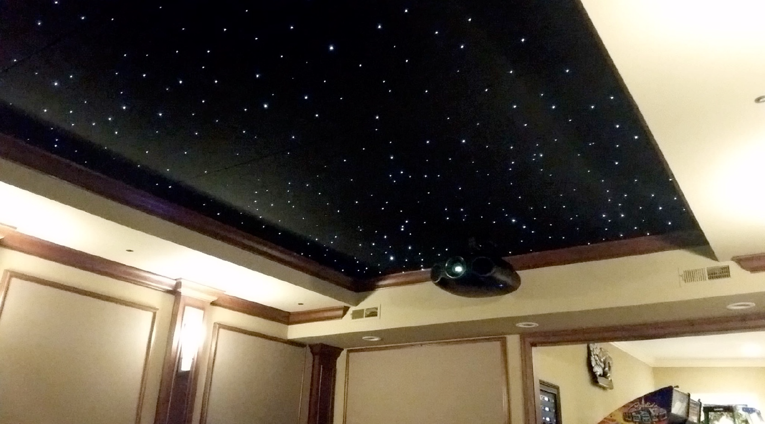 A room with a flat screen tv and speakers