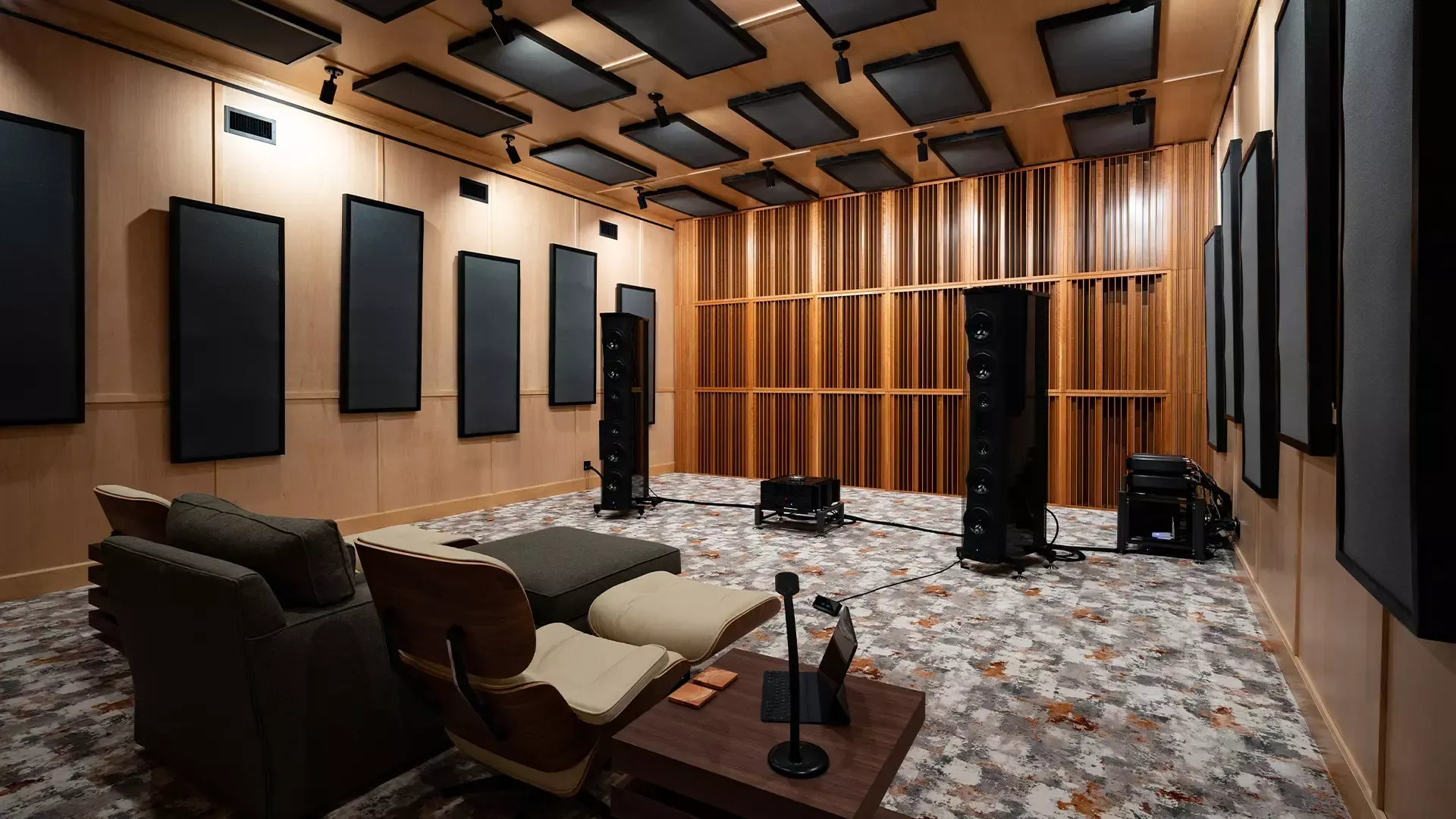 A large room with a lot of furniture and speakers in it.