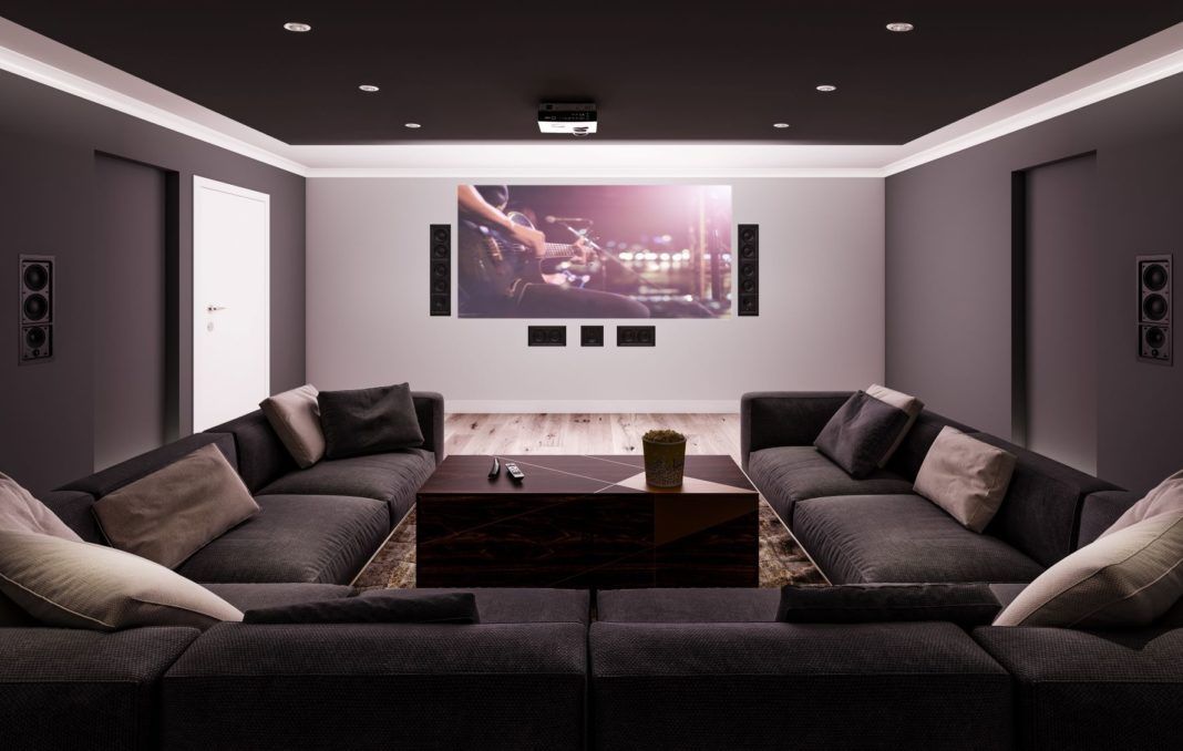 A room with a flat screen tv and speakers