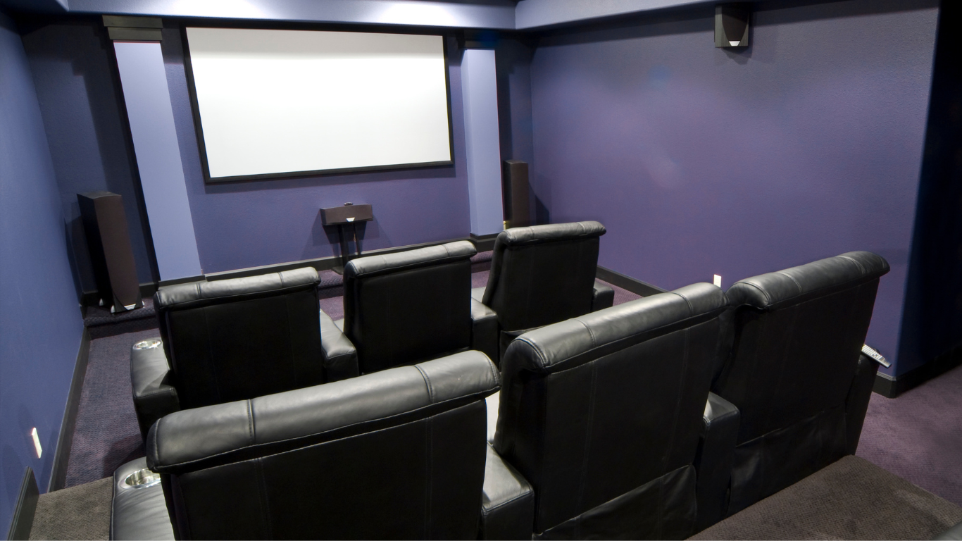 A row of brown leather seats in a theater