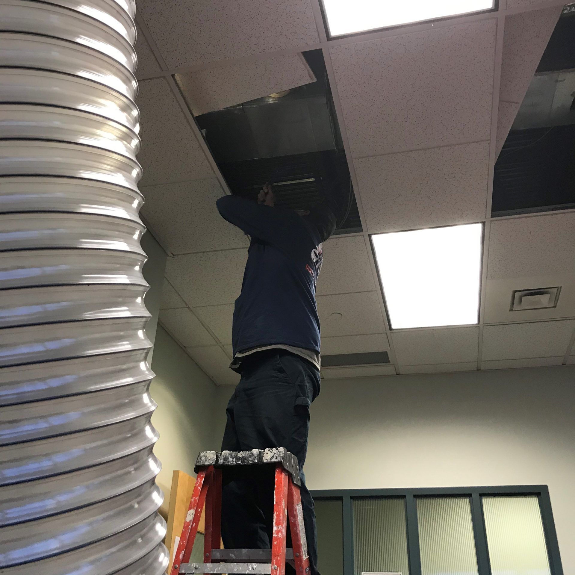 A Man on A Ladder Is Working on A Ceiling 2 | S. Glens Falls, NY | Performance Industrial