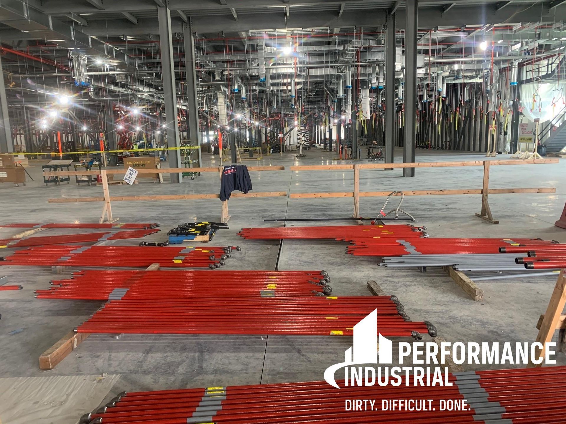 A large building under construction with a sign that says performance industrial