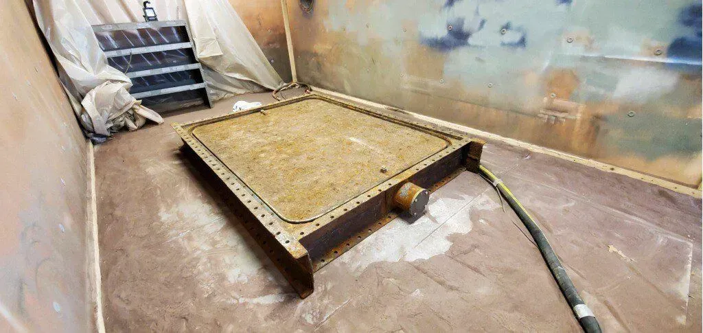 There is a hose coming out of a hole in the floor.