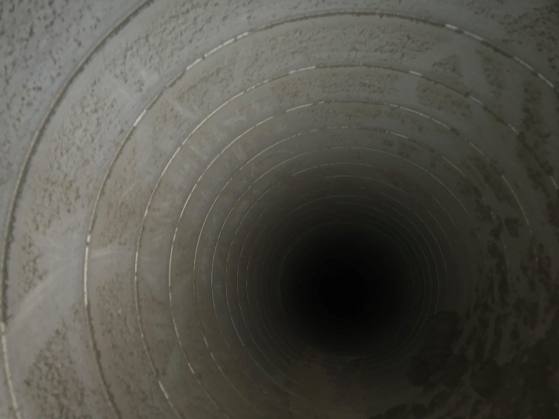 A Close Up Of A Concrete Pipe Going Through A Dark Tunnel | S. Glens Falls, NY | Performance Industrial